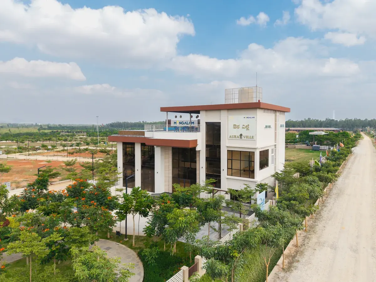 Aura Ville clubhouse surrounded by landscaped greenery